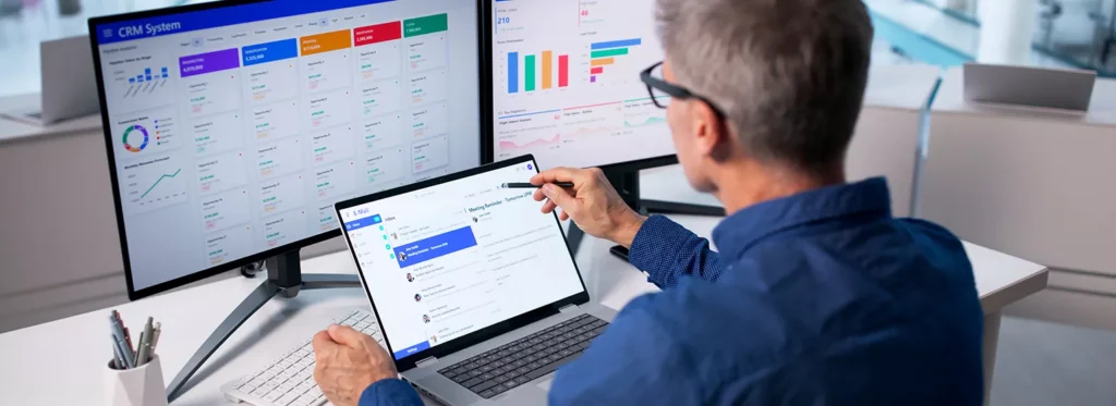 Paradigm - Man Looking at Analytics on his Computer - 1538x560